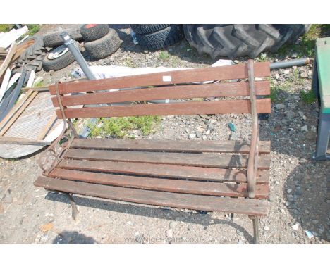 A wooden bench with cast iron supports.