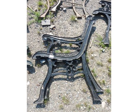 A pair of cast iron bench ends with heart pattern.