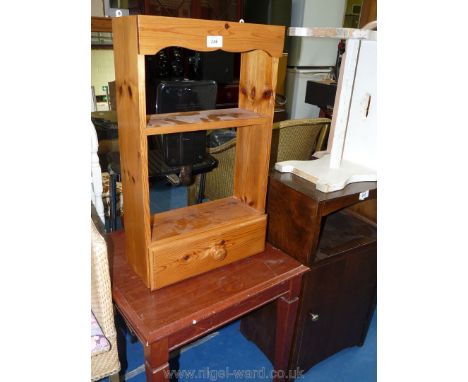 A small pine kitchen shelf unit with a drawer and a dark-wood coffee table.