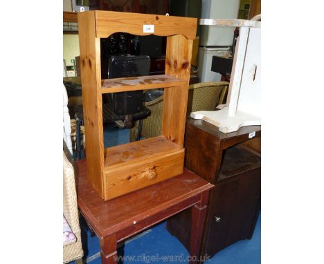 A small pine kitchen shelf unit with a drawer and a dark-wood coffee table.