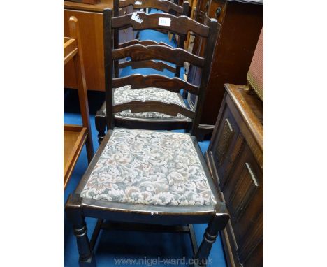 A pair of ladder-back chairs with drop-in seats.