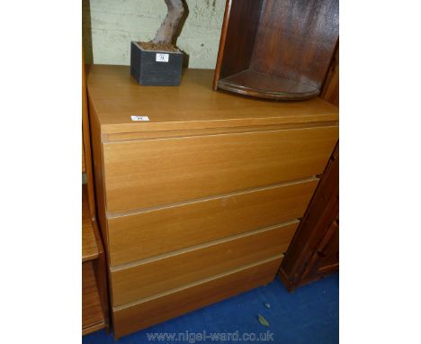 A light Oak finished chest of four long drawers.