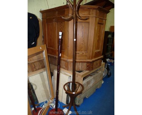 A bentwood hat &amp; coat stand and a dark-wood standard lamp, no shade present.