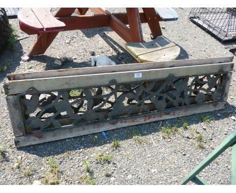 Two metal and wooden garden bench backs with trailing flowering stem pattern.