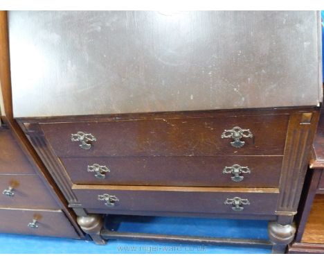 An Oak bureau having a light Oak finished interior and with three long drawers below and standing on brief bulbous turned leg