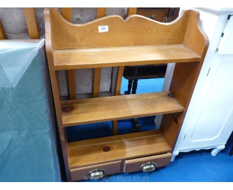 A Pine wall-hanging triple shelf unit with two small drawers to the base.