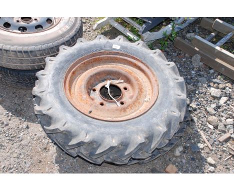 Two wheels and tractor rear tread pattern tyres: Continental 6.00-16 AS one being on a Land-Rover rim the other 5-stud but no