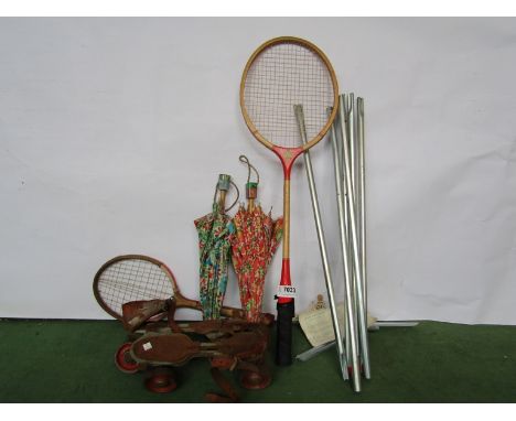 A pair of vintage roller skates, badminton rackets etc