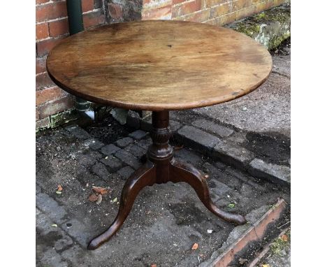 A George III and later mahogany tripod table, circular top (some staining) raised on a turned column supported by three cabri