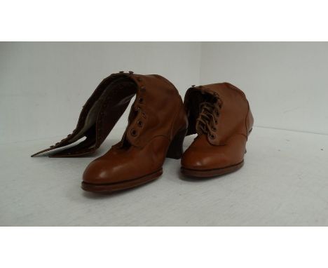 A pair of Victorian long mid brown leather ladies boots with a Cuban heels, with a long tab laces and stud/button fastening, 