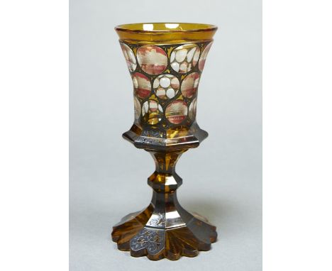 A BOHEMIAN AMBER CASED, RUBY FLASHED ENGRAVED AND ENAMELLED GLASS GOBLET, C1860, THE FLARED BOWL ENGRAVED WITH TWELVE NAMED V