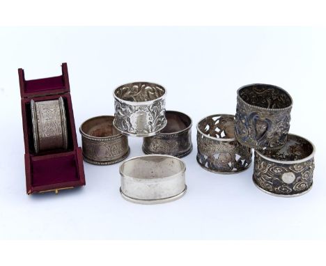 TWO CHINESE SILVER REPOUSSE DRAGON NAPKIN RINGS, LATE 19TH C AND SIX, MAINLY VICTORIAN, ENGLISH SILVER NAPKIN RINGS, ONE CASE