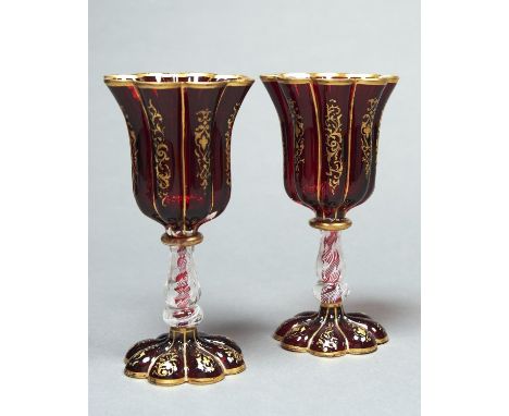 A PAIR OF RUBY STAINED GLASS GOBLETS, PROBABLY FRENCH, MID 19TH C, THE LOBED GILT BELL SHAPED BOWL ON FACETED AND KNOPPED BAL