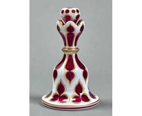 A CASED GLASS SCENT BOTTLE AND STOPPER, MID 19TH C, OF RUBY GLASS CASED IN WHITE AND GILT, BELL SHAPED WITH FLORIFORM NECK AN