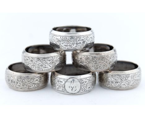 A PART SET OF SIX VICTORIAN SILVER NAPKIN RINGS, FOLIATE ENGRAVED, INITIALLED R AND NUMBERED, BY WILLIAM M HAYES, BIRMINGHAM 