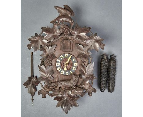A GERMAN CARVED AND STAINED WOOD WALL HANGING CUCKOO CLOCK OF TYPICAL FORM, APPLIED WITH FOLIAGE AND GLASS EYED FOX, WOOD LEA