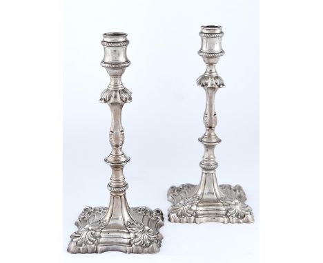 A PAIR OF GEORGE II&nbsp; SILVER CANDLESTICKS, THE WAISTED SCONCE ON MUSHROOM KNOPPED PILLAR WITH TWO LOWER KNOPS AND STEPPED