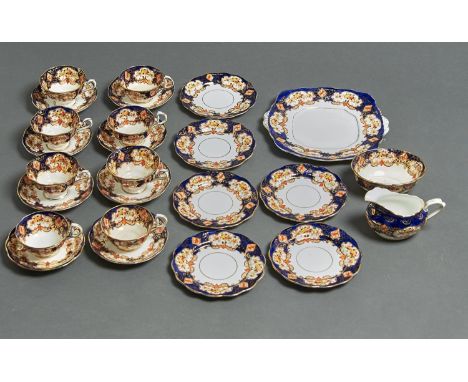 A ROYAL ALBERT HEIRLOOM TEA SERVICE, PRINTED AND PAINTED WITH FLOWERS AND LEAFAGE WITHIN GILT FRAMES ON ROYAL BLUE GROUND WIT