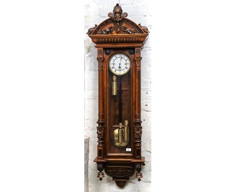 A WALNUT TRIPLE WEIGHT VIENNA WALL CLOCK, LATE 19TH C, WITH ENAMEL DIAL AND PIERCED HANDS, FIGURED PANEL TO THE BACK, THE ARC