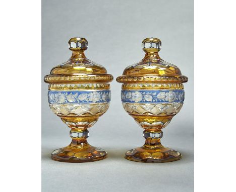 A PAIR OF BOHEMIAN CUT AND BLUE AND AMBER FLASHED GLASS SWEETMEAT JARS AND COVERS, EARLY 20TH C, THE FACETS OUTLINED IN BLUE 