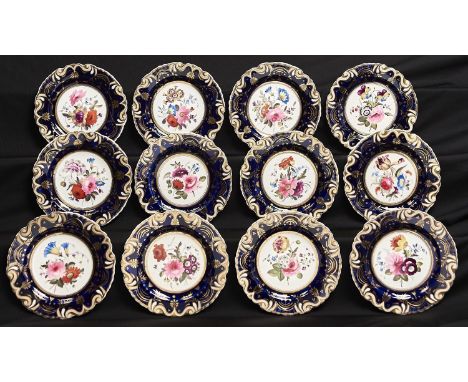 A SET OF TWELVE JOHN AND WILLIAM RIDGWAY DESSERT PLATES, C1825, PAINTED WITH FLOWERS IN MOULDED BLUE AND GILT BORDER, 21.5CM 