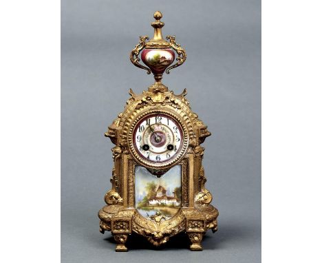 A FRENCH SPELTER GILT AND PORCELAIN MOUNTED MANTEL CLOCK, C1900, IN LOUIS XVI STYLE, WITH CLARET GROUND VASE FINIAL, FLORAL P