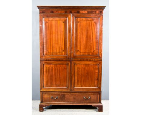 A 19th Century Figured Mahogany Gentleman's Wardrobe with moulded dentil cornice, plain frieze, the front inlaid with ebony s