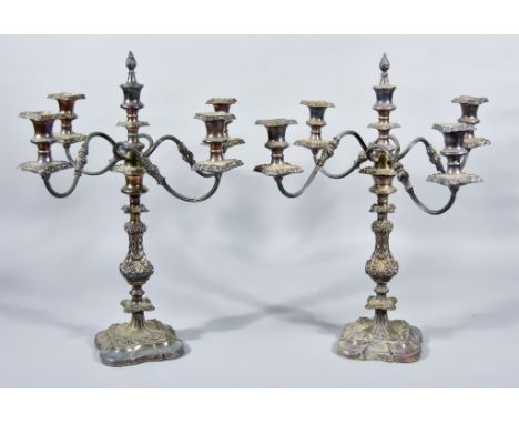 A Pair of Plated Five Light Candelabra, the leaf and scroll cast and knopped stem with turned finial, four reeded scroll bran
