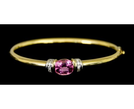 An 18ct Gold Amethyst and Diamond Stiff Bracelet, set with a centre pink amethyst stone of approximately 2ct, flanked either 