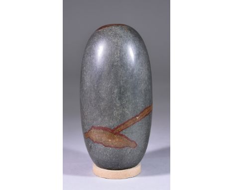 A Shiva Lingam Stone, of dark grey polished stone with red inclusions to top and body, approximately 6.5ins highThere is a mi