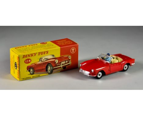 A Dinky Toys&nbsp;Diecast Model Car No. 114, "Triumph Spitfire", with red body, spun hub, figure sat in cream interior, in or