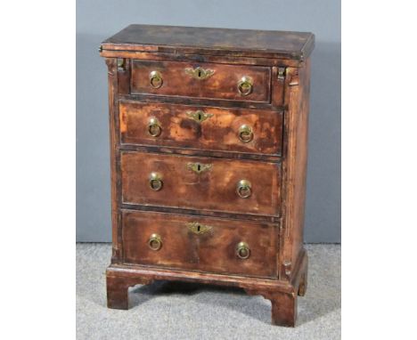 An 18th Century Walnut Bachelors Chest, with moulded edge, cross banding and re-entrant corners to the folding top, fitted fo