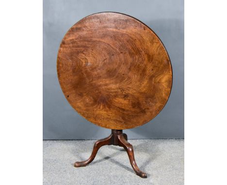 A George III Mahogany Tripod Occasional Table, with single plank top, on baluster turned and reeded central column, and cabri