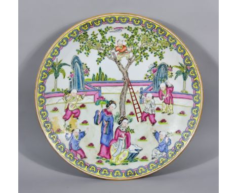 A 20th Century Chinese Famille Rose Porcelain Charger, decorated with scene of child playing in tree surrounded by various fi