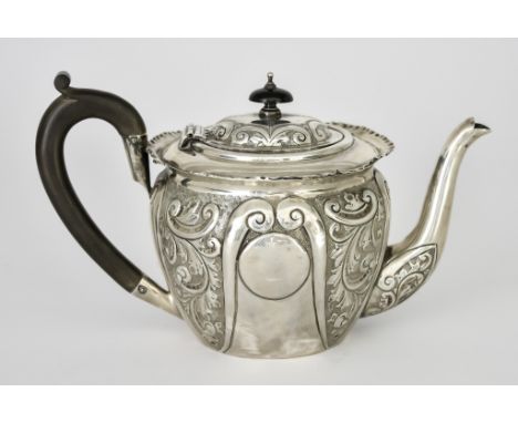 A Late Victorian Silver Circular Teapot by William Devenport, Birmingham 1900, with shaped rim, the whole embossed with leaf 