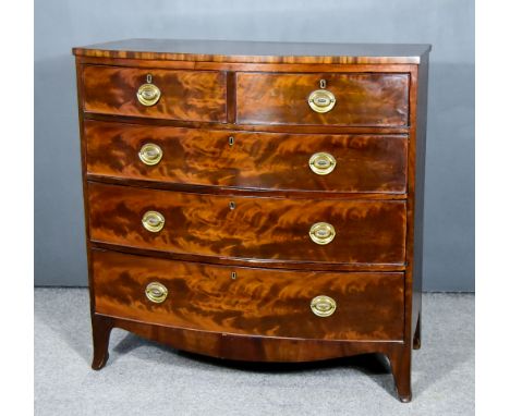 A George III Figured Mahogany Bow Front Chest with square edge to top, fitted two short and three long drawers, on shaped apr