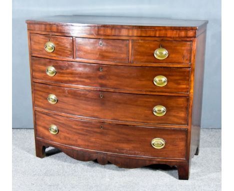 A George III Mahogany Bow Front Chest with square edge to top, the frieze inlaid with ebonised stringing, fitted three short 