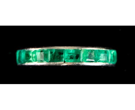 An Emerald Eternity Ring, set with faceted emerald stones, size N, total gross weight 7g Note: Metal unmarked but tests as 18