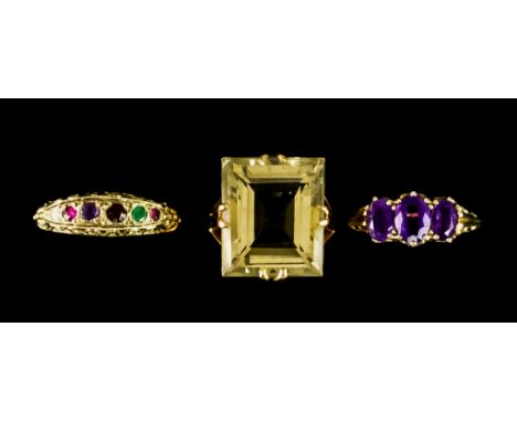 Three Gem Set Dress Rings, comprising - a large faceted smoky quartz ring with high shank, size M, a three stone amethyst rin