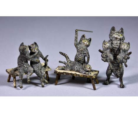 Four Cold Painted Bronze Cat Groups, in the style of Franz Bergman (1861-1936) comprising - a cat standing on its hind legs h