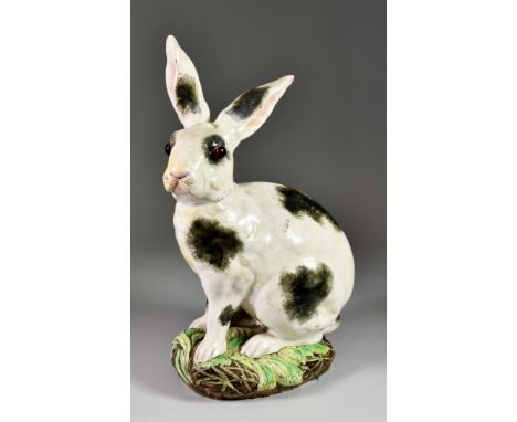 Galle Pottery Seated Figure of a Black and White Rabbit with Glass Eyes, on naturalistic base, with small vase modelled as a 