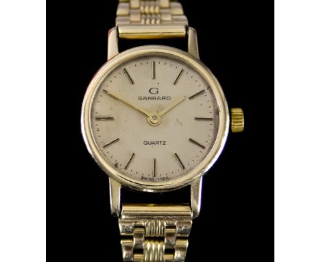 A Lady's Quartz Wristwatch by Garrard, 20mm 9ct gold case with cream dial and gold baton numerals, on 9ct gold bracelet, 170m