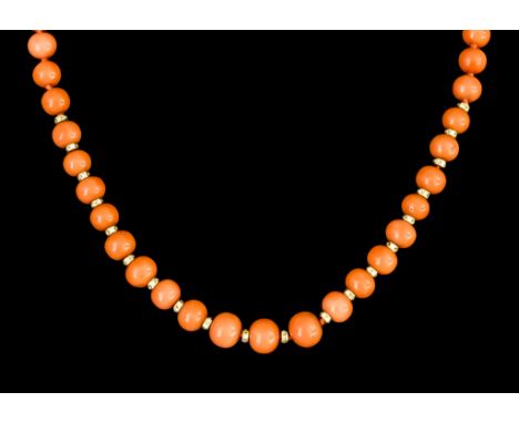 A String of Coral Coloured Beads, with yellow metal clasp (tests as 18ct gold) in the form of a purse, inlaid with small diam
