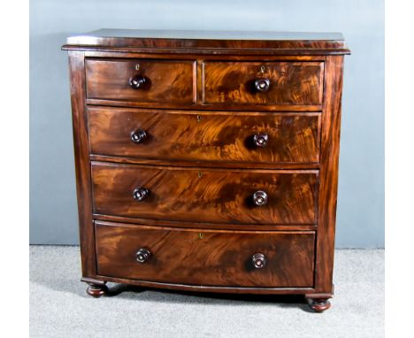 A Victorian Figured Mahogany Bow Front Chest with square and moulded edge to top, fitted two short and three long drawers on 