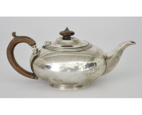 A George IV Silver Circular Teapot by Charles Fox, London 1824, of squat bulbous form with turned wood finial and scroll hand