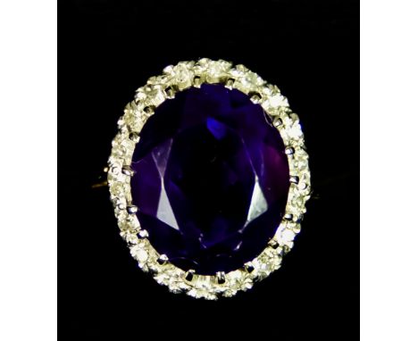 An 18ct Gold&nbsp; Amethyst and Diamond Ring, set with a centre faceted amethyst stone, approximately 3ct, surrounded by smal