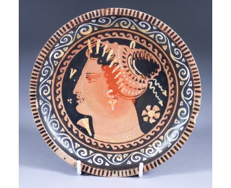 A Gnathian Red Figure Plate on High Foot, 4th Century BC, painted with a female profile head wearing a stephane, pendant earr