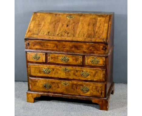 An 18th Century Figured Walnut Bureau, the whole inlaid with herringbone bandings, with fitted interior comprising central cu