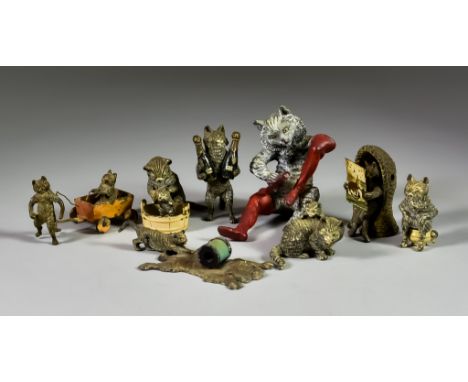A Small Selection of Cold Painted Cat Bronzes, in the Austrian manner, comprising: - a reading cat seated in a woven porter's