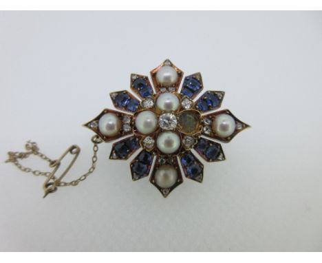A Victorian diamond, sapphire and half pearl brooch, designed as a quatrefoil of half pearls (not tested, one lacking) around